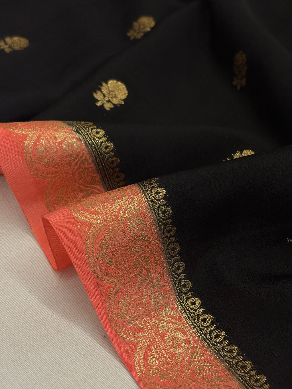 Jet Black Crepe Silk Saree with Gold Zari Buti & Coral Peach Brocade Border