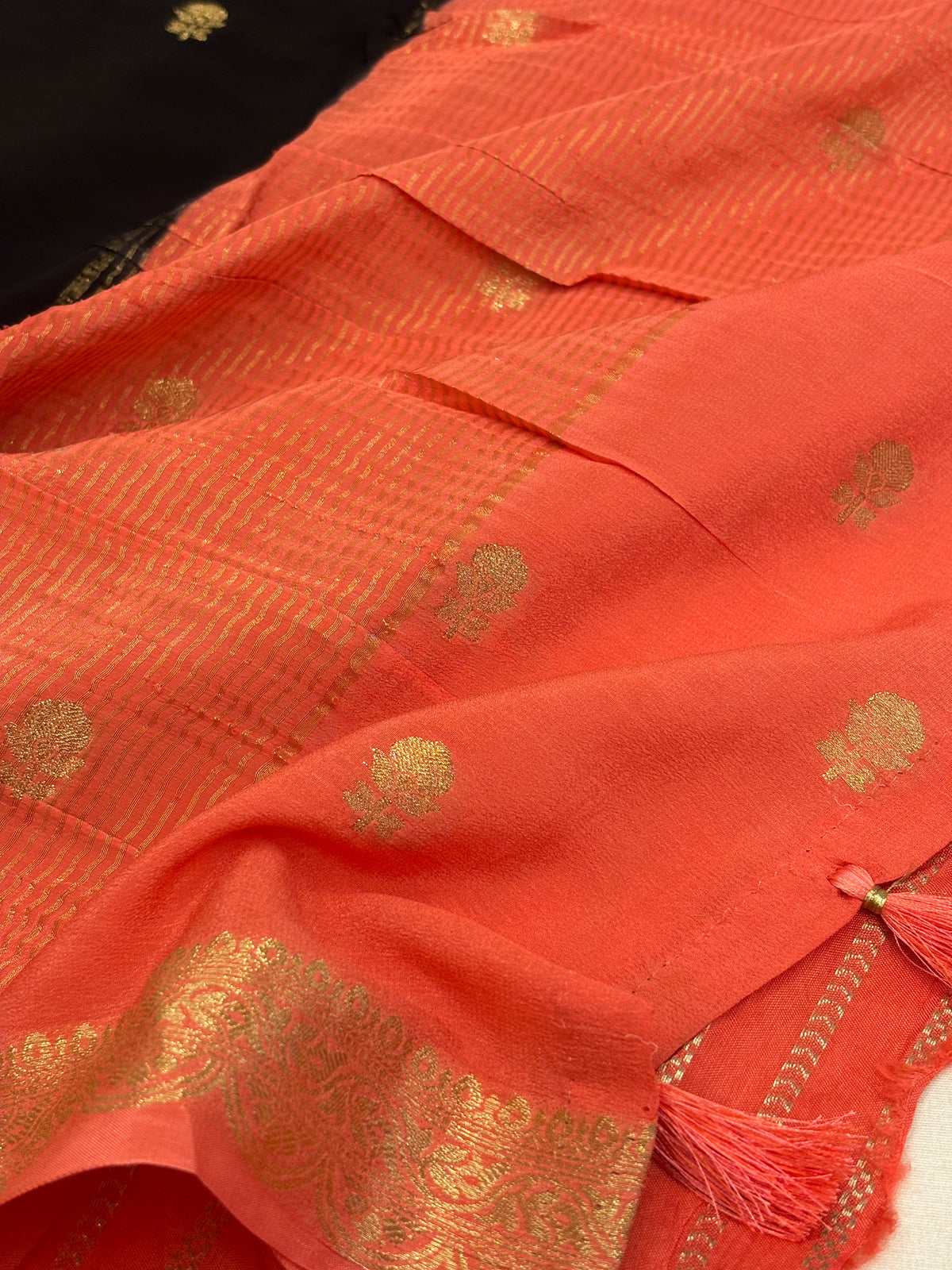 Jet Black Crepe Silk Saree with Gold Zari Buti & Coral Peach Brocade Border
